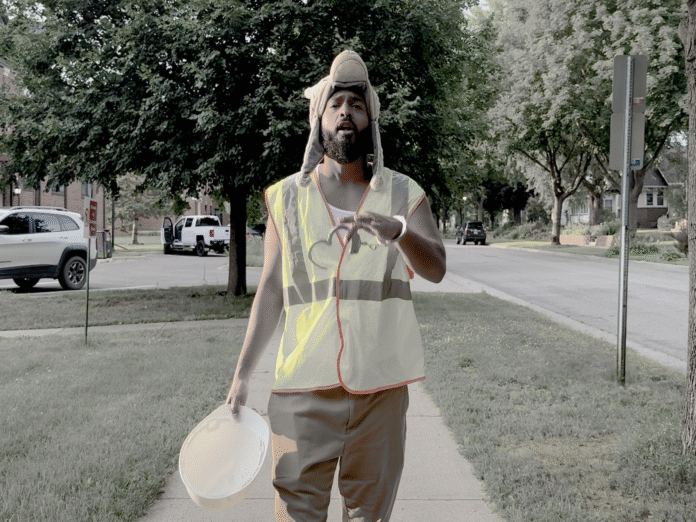 Rapper Zander, an American in a construction vest with a handcuff on his wrist in the 