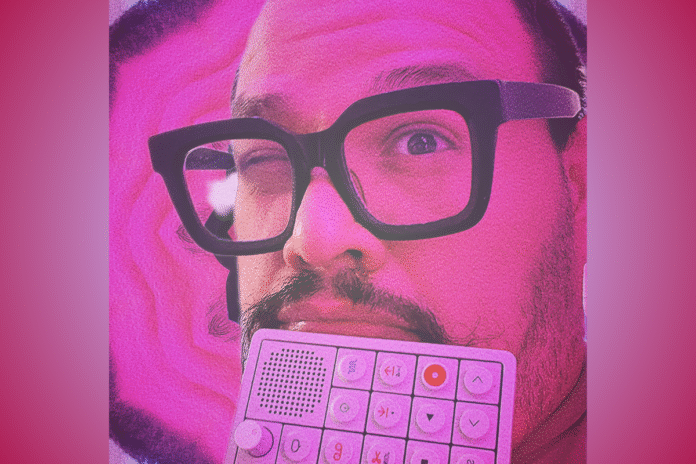 Frank Panduh pictured with thick-framed glasses holding a white music production pad with a gradient pink backdrop; feature photo for a review of his single 